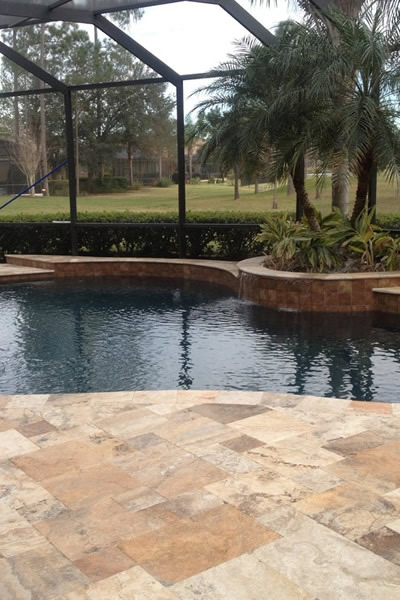 Beige Pool Surround with Travertine Coping – High-End Resort Style